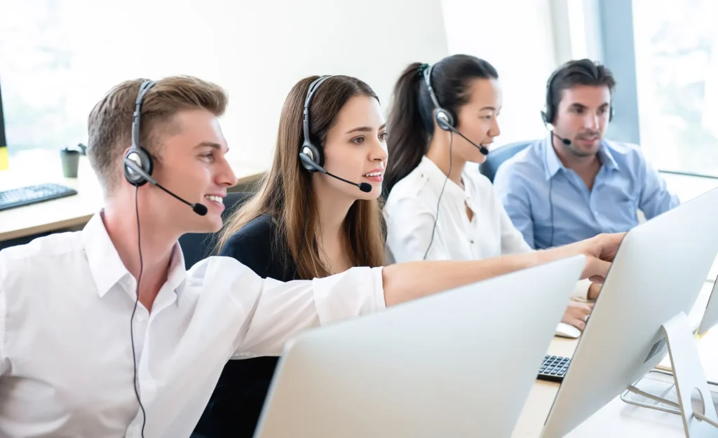 Telemarketing team working together in call center office