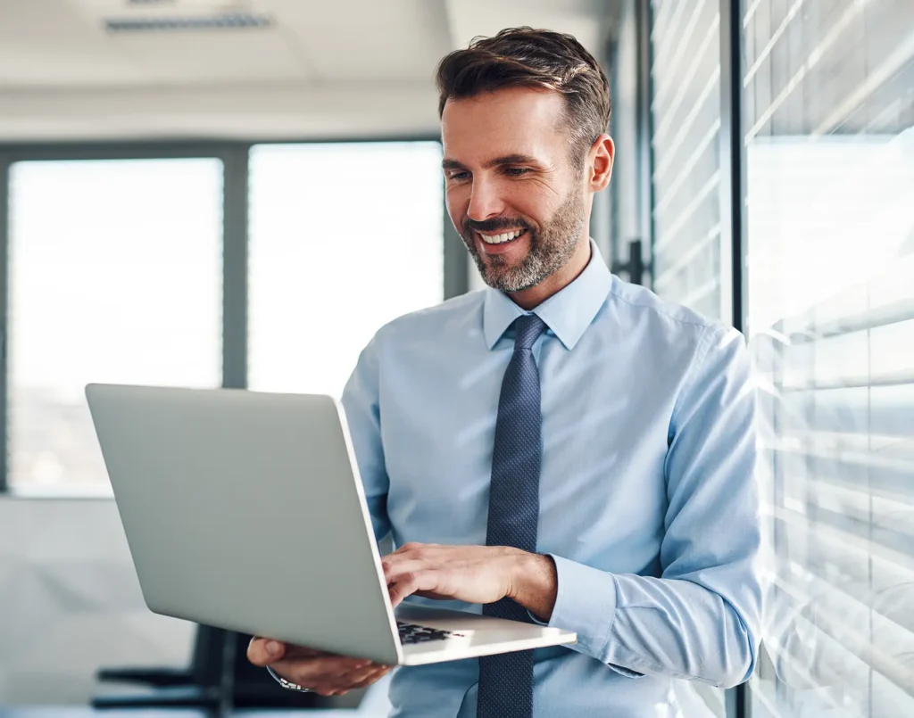 Businessman in modern office working on laptop